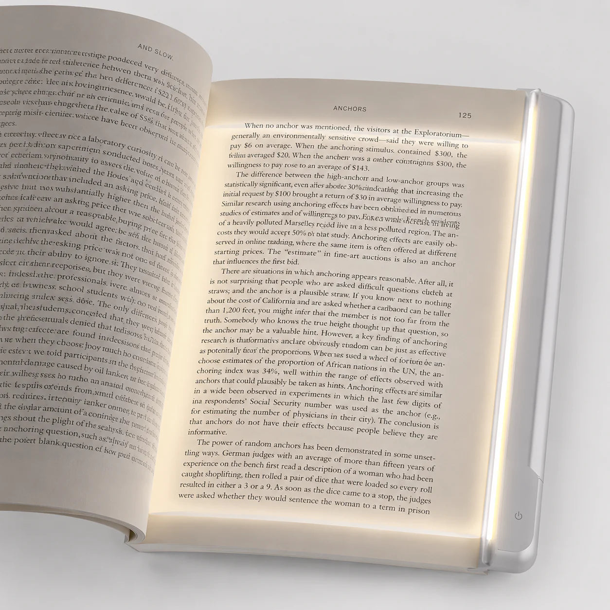 LumiPage clipped on an open book casting soft amber light